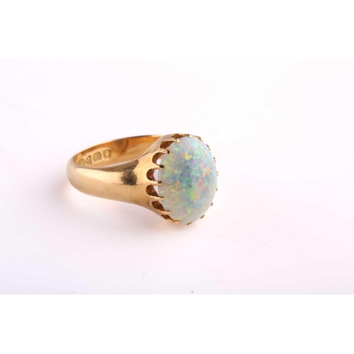 167 - A precious opal dress ring in 18ct yellow gold, composed of an oval precious opal cabochon, approxim... 