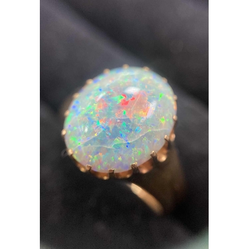 167 - A precious opal dress ring in 18ct yellow gold, composed of an oval precious opal cabochon, approxim... 