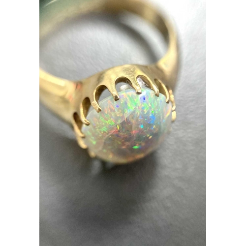 167 - A precious opal dress ring in 18ct yellow gold, composed of an oval precious opal cabochon, approxim... 