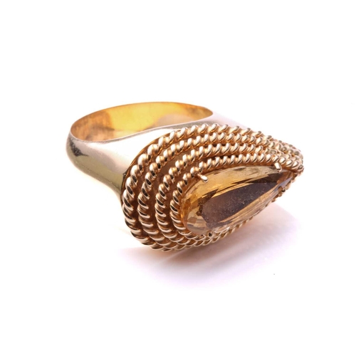 175 - A gold and citrine dress ring; the horizontally set pear-shaped citrine in claw mounts above a four-... 