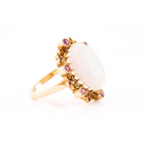 178 - A precious opal dress ring, featuring an oval precious opal cabochon of 16.0 x 12.2 x 4.7 mm, with s... 