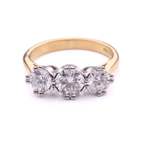 181 - A three-stone diamond half-hoop ring in 18ct gold, comprising three graduated circular brilliant-cut... 