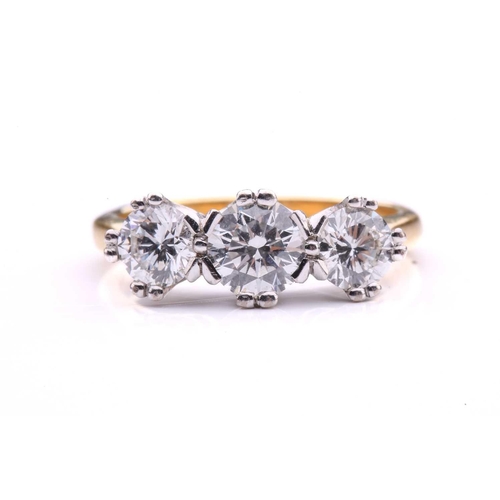 181 - A three-stone diamond half-hoop ring in 18ct gold, comprising three graduated circular brilliant-cut... 