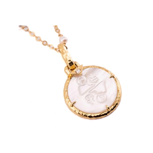 182 - A mother-of-pearl zodiac necklace by Peggy Daven, comprising a round mother-of-pearl plaque with a r... 