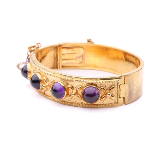 187 - A Late Victorian five-stone amethyst hinged bangle, comprising five high-domed amethyst cabochons in... 