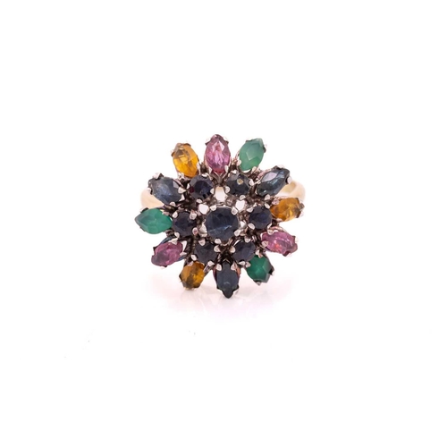 212 - A gem-set flower dome ring, centred with a tiered cluster of circular-cut sapphires, surrounded by a... 