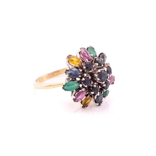 212 - A gem-set flower dome ring, centred with a tiered cluster of circular-cut sapphires, surrounded by a... 