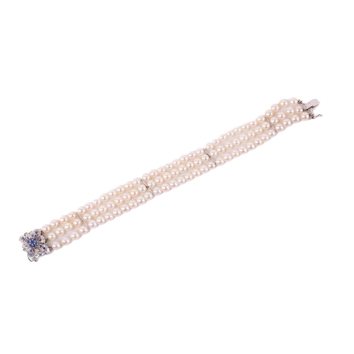 218 - A three-row pearl bracelet with gem-set clasp, comprising uniformed round cultured pearls of 5.0 mm ... 