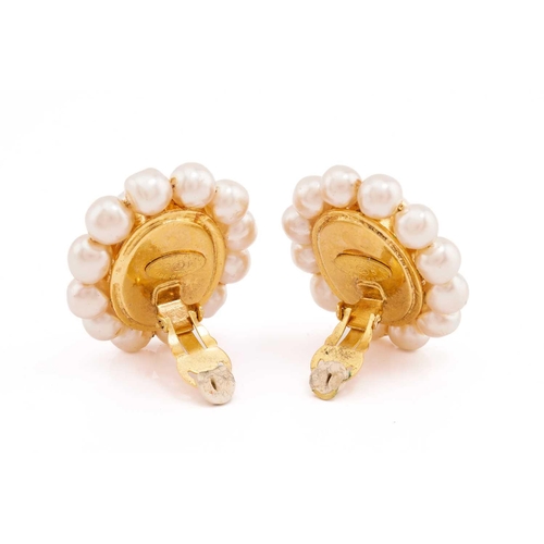 228 - Chanel - Two pairs of clip-on earrings; including a pair of cluster earrings, each centred with an o... 