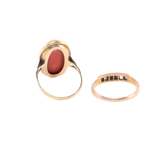 232 - A precious coral ring and an emerald half-hoop ring; the coral dress ring comprises a large oval-sha... 