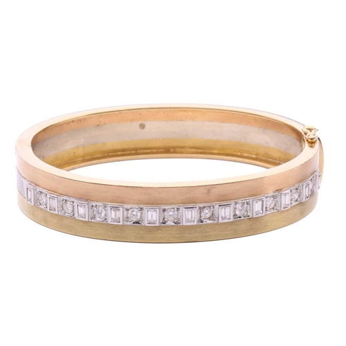 237 - A tri-coloured hinged bangle set with diamonds, featuring eleven collet-set baguette diamonds, alter... 