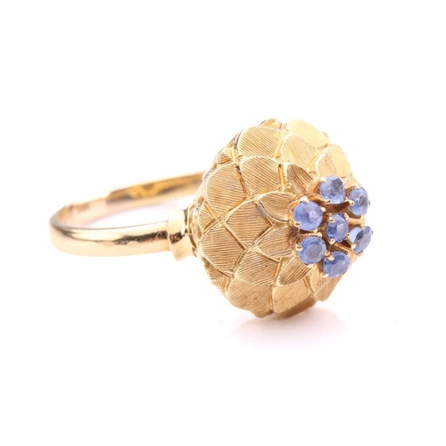 242 - A sapphire-set dome ring, in the form of an artichoke, centrally set with a cluster of seven circula... 