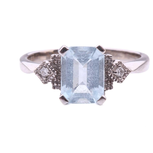 247 - An aquamarine and diamond dress ring in 18ct white gold, comprising an emerald-cut pale blue aquamar... 