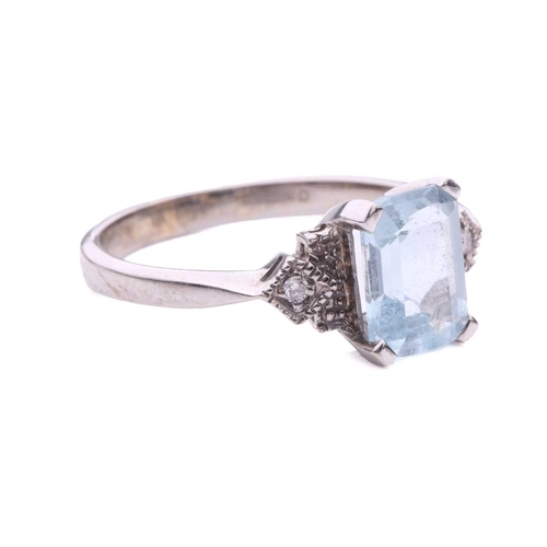 247 - An aquamarine and diamond dress ring in 18ct white gold, comprising an emerald-cut pale blue aquamar... 