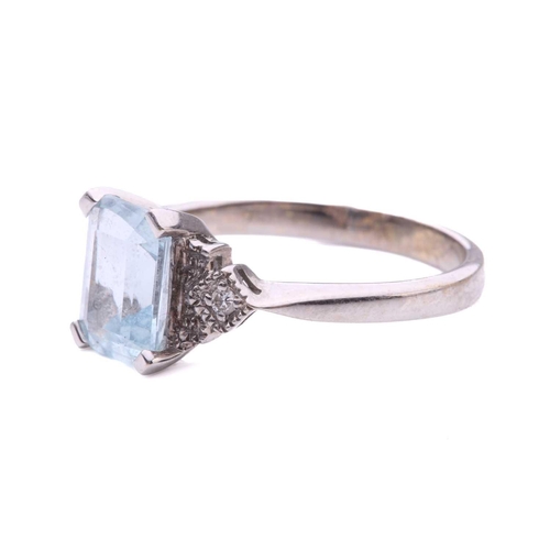 247 - An aquamarine and diamond dress ring in 18ct white gold, comprising an emerald-cut pale blue aquamar... 