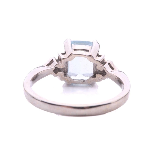 247 - An aquamarine and diamond dress ring in 18ct white gold, comprising an emerald-cut pale blue aquamar... 