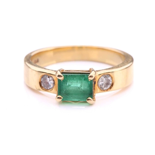 251 - An emerald and diamond dress ring in 18ct yellow gold, comprising an emerald-cut emerald in dark gre... 