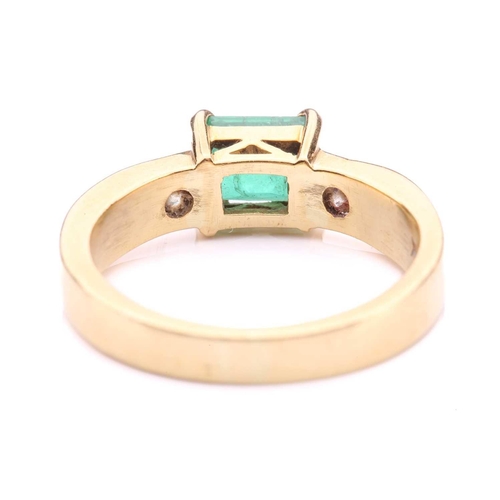 251 - An emerald and diamond dress ring in 18ct yellow gold, comprising an emerald-cut emerald in dark gre... 