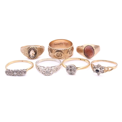 252 - A collection of seven rings, comprising a 9ct gold wedding band decorated with hearts on a textured ... 