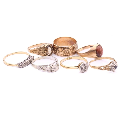 252 - A collection of seven rings, comprising a 9ct gold wedding band decorated with hearts on a textured ... 