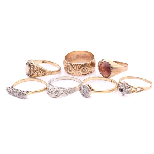 252 - A collection of seven rings, comprising a 9ct gold wedding band decorated with hearts on a textured ... 