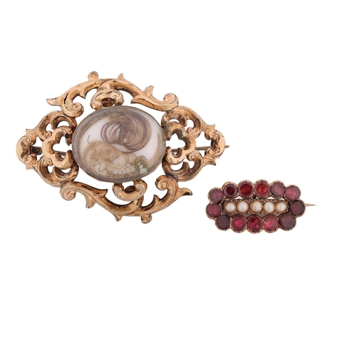 256 - Two early 19th-century brooches; including a mourning brooch with a double glass compartment, encasi... 