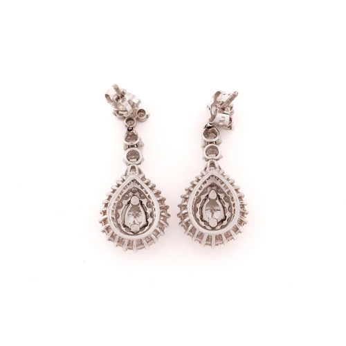 259 - A pair of white gold and diamond drop pendant earrings, each set with a mixed pear-cut diamond, meas... 