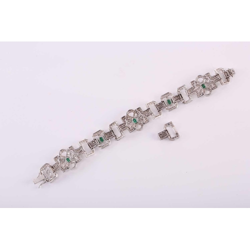 26 - An Art Deco-style emerald and diamond bracelet, designed as geometric openwork links, encrusted with... 