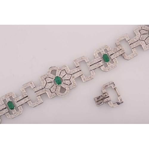 26 - An Art Deco-style emerald and diamond bracelet, designed as geometric openwork links, encrusted with... 