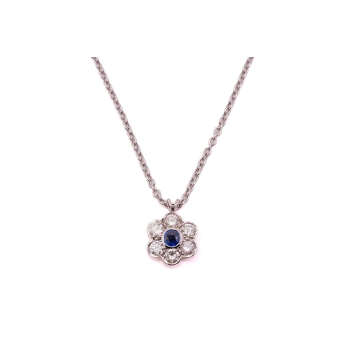 266 - A sapphire and diamond cluster pendant on chain, the round mixed cut sapphire, rub over set, approxi... 