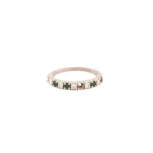 268 - An emerald and diamond half eternity ring in 18ct white gold, comprises five round brilliant-cut dia... 