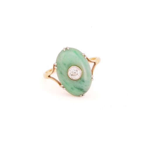 27 - A jade and diamond ring, the oval jade cabochon measuring approximately 17 x 12mm, centred by an old... 