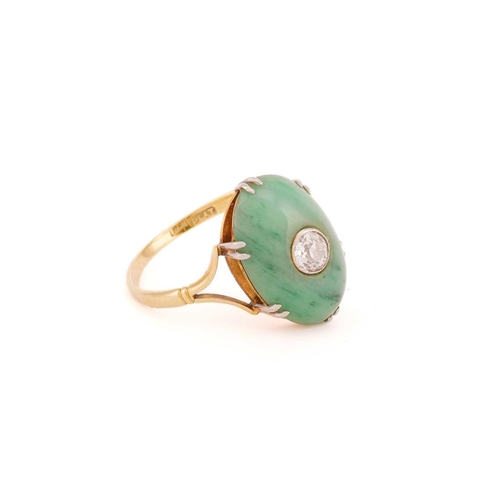 27 - A jade and diamond ring, the oval jade cabochon measuring approximately 17 x 12mm, centred by an old... 