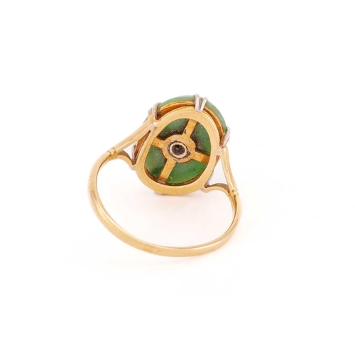 27 - A jade and diamond ring, the oval jade cabochon measuring approximately 17 x 12mm, centred by an old... 