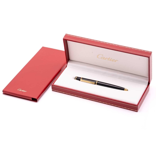 274 - A Cartier ballpoint pen, featuring black resin and gold plated parts with a twist design and set wit... 