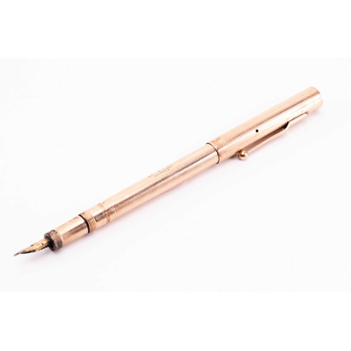 275 - A Mabie Todd & Co 'Swan' 9k gold fountain pen, circa 1925, with engine turned decoration, the body w... 