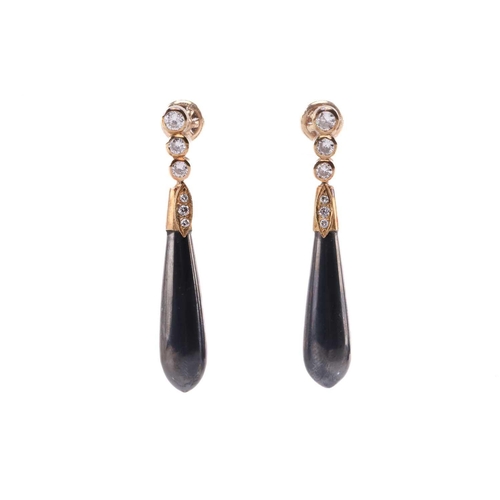 28 - A pair of hematite and diamond pendant earrings, each containing an elongated teardrop-shaped hemati... 