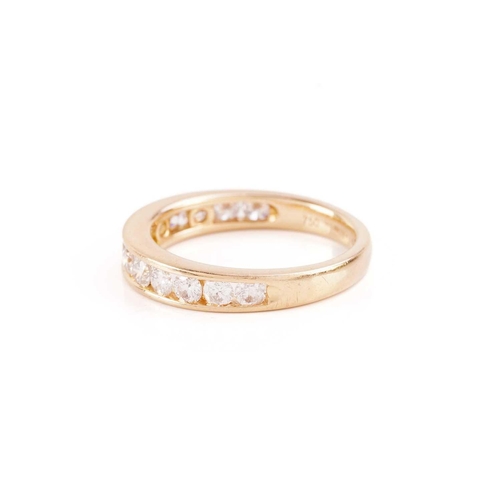 33 - A diamond half-eternity ring in 18ct yellow gold, channel-set with thirteen graduated brilliant-cut ... 