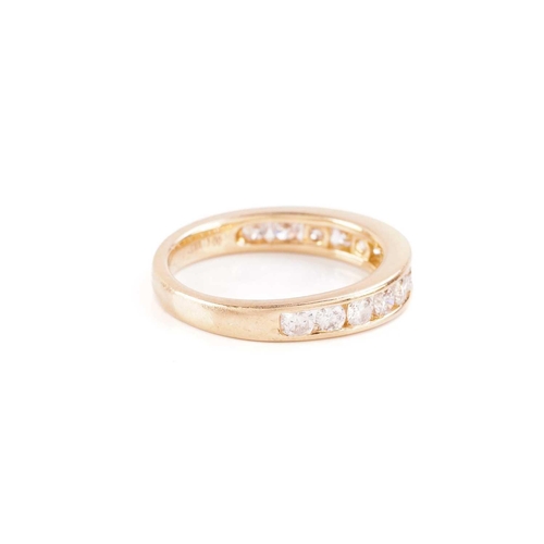 33 - A diamond half-eternity ring in 18ct yellow gold, channel-set with thirteen graduated brilliant-cut ... 