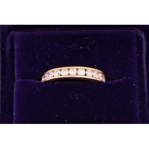 33 - A diamond half-eternity ring in 18ct yellow gold, channel-set with thirteen graduated brilliant-cut ... 