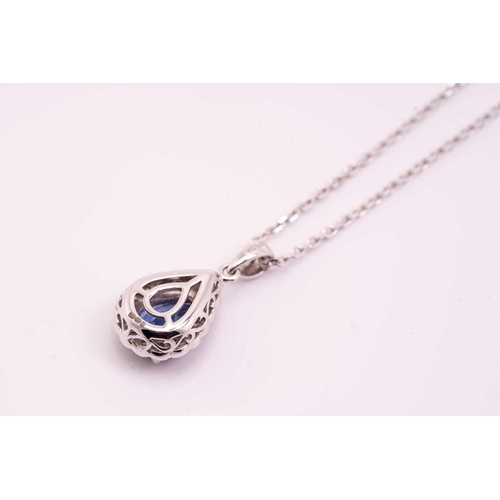 34 - A tanzanite and diamond cluster pendant on chain, featuring a pear-shaped tanzanite of 8.3 x 5.6 mm,... 