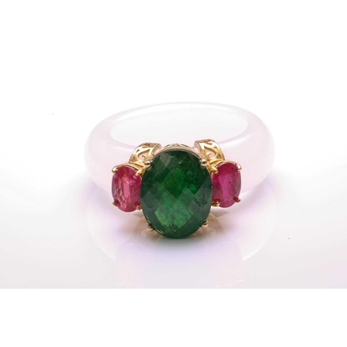 37 - A carved white nephrite jade ring set with tsavorite and rubies, with a D-section band carved out of... 