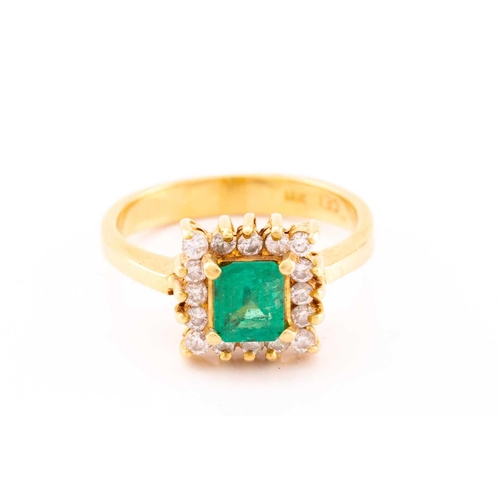 43 - An emerald and diamond entourage ring, centred with an emerald-cut emerald in bright green colour, a... 