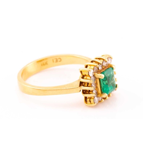 43 - An emerald and diamond entourage ring, centred with an emerald-cut emerald in bright green colour, a... 