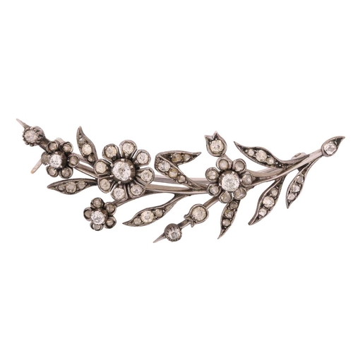 47 - A daisy spray brooch set with old-cut diamonds, comprising realistically formed flowerheads and foli... 