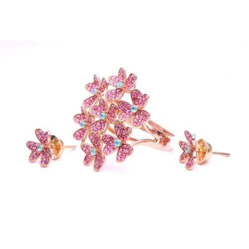 49 - A floral dress ring and earrings en suite; the ring is composed of seven foliate gem set clusters se... 