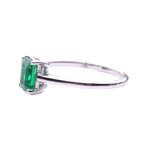 50 - An emerald solitaire ring, featuring an emerald-cut emerald with intense green body colour, approxim... 