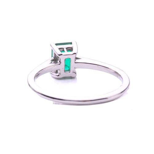 50 - An emerald solitaire ring, featuring an emerald-cut emerald with intense green body colour, approxim... 