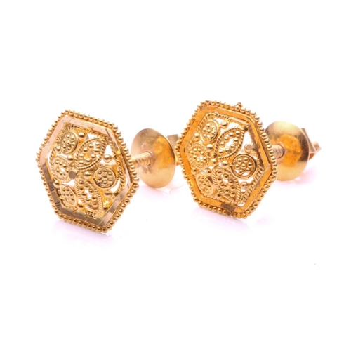 51 - A pair of 22ct yellow gold stud earrings, each consisting of a domed floral motif in the centre, fra... 