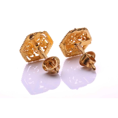 51 - A pair of 22ct yellow gold stud earrings, each consisting of a domed floral motif in the centre, fra... 